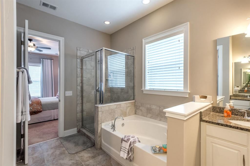 Large master bath with huge tub and glass shower.