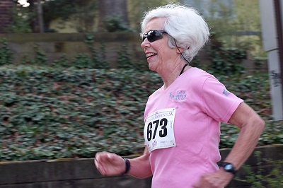 Woman running a 5K outside.